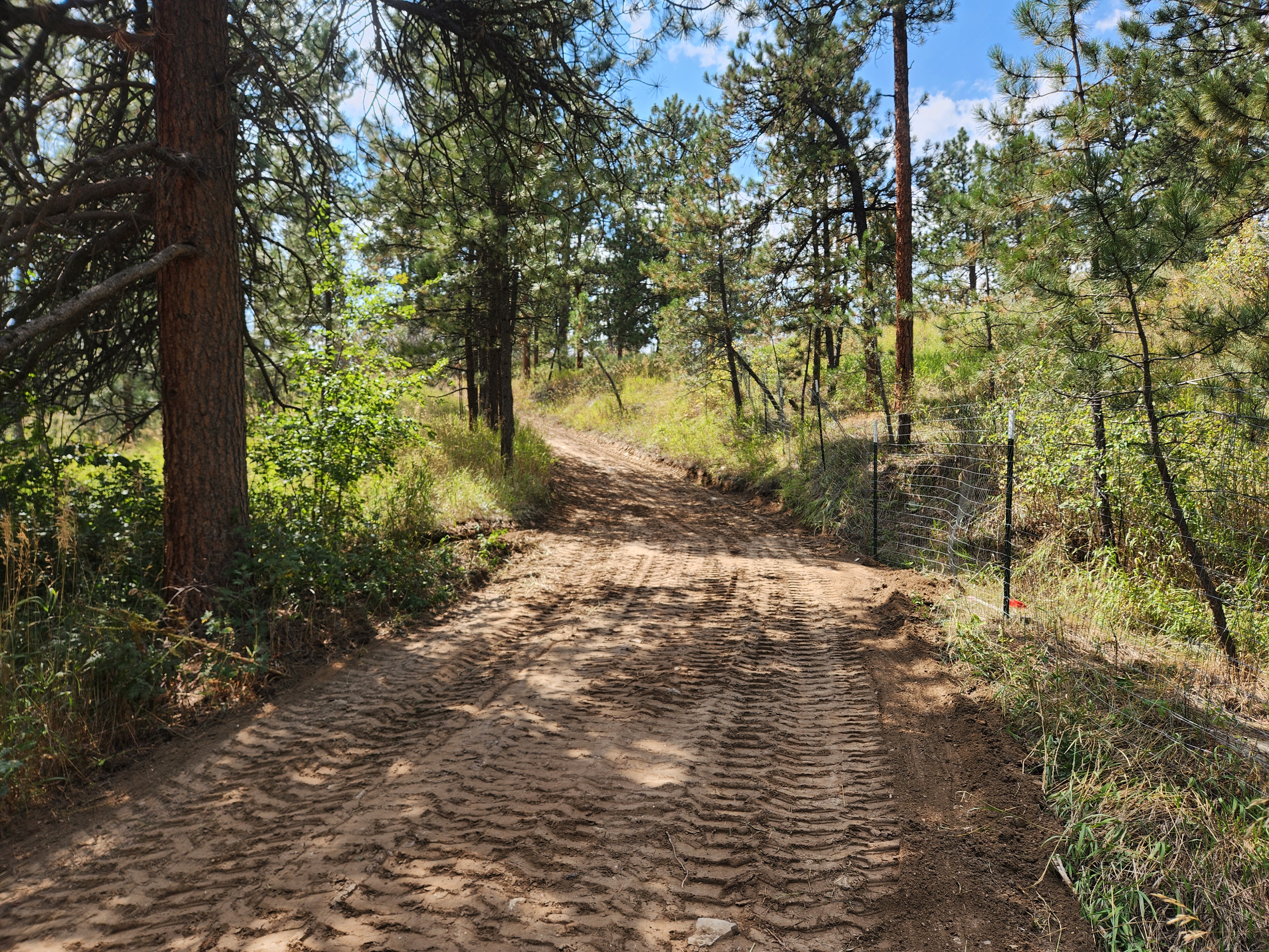 Washout repaired — road rebuilt with fresh material and tractor work